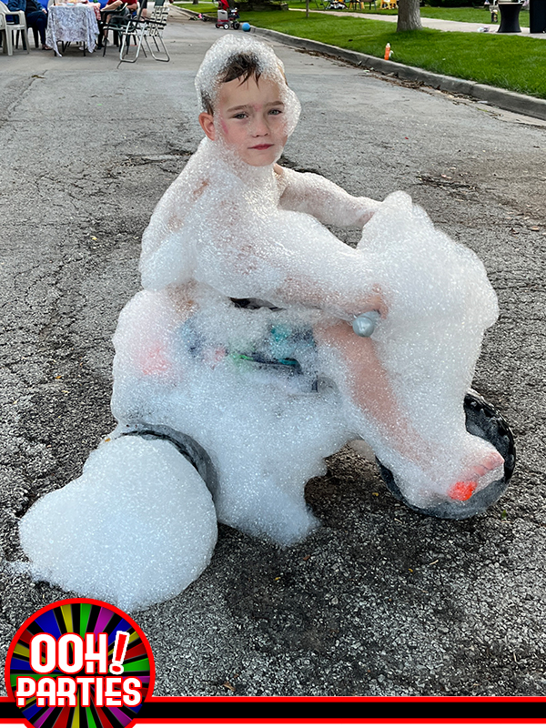 child on tricycle covered in foam